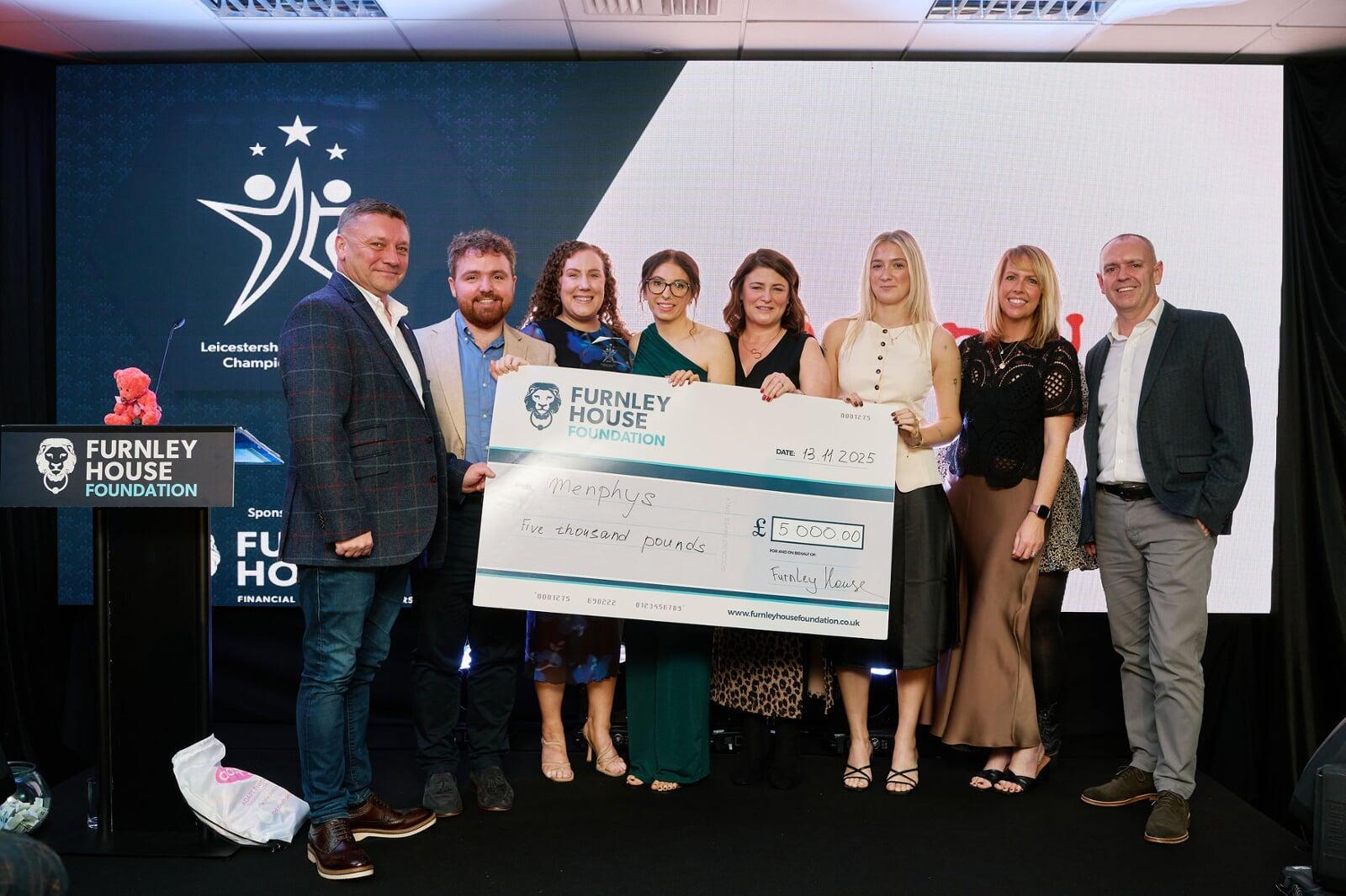 A charity being presented with a cheque