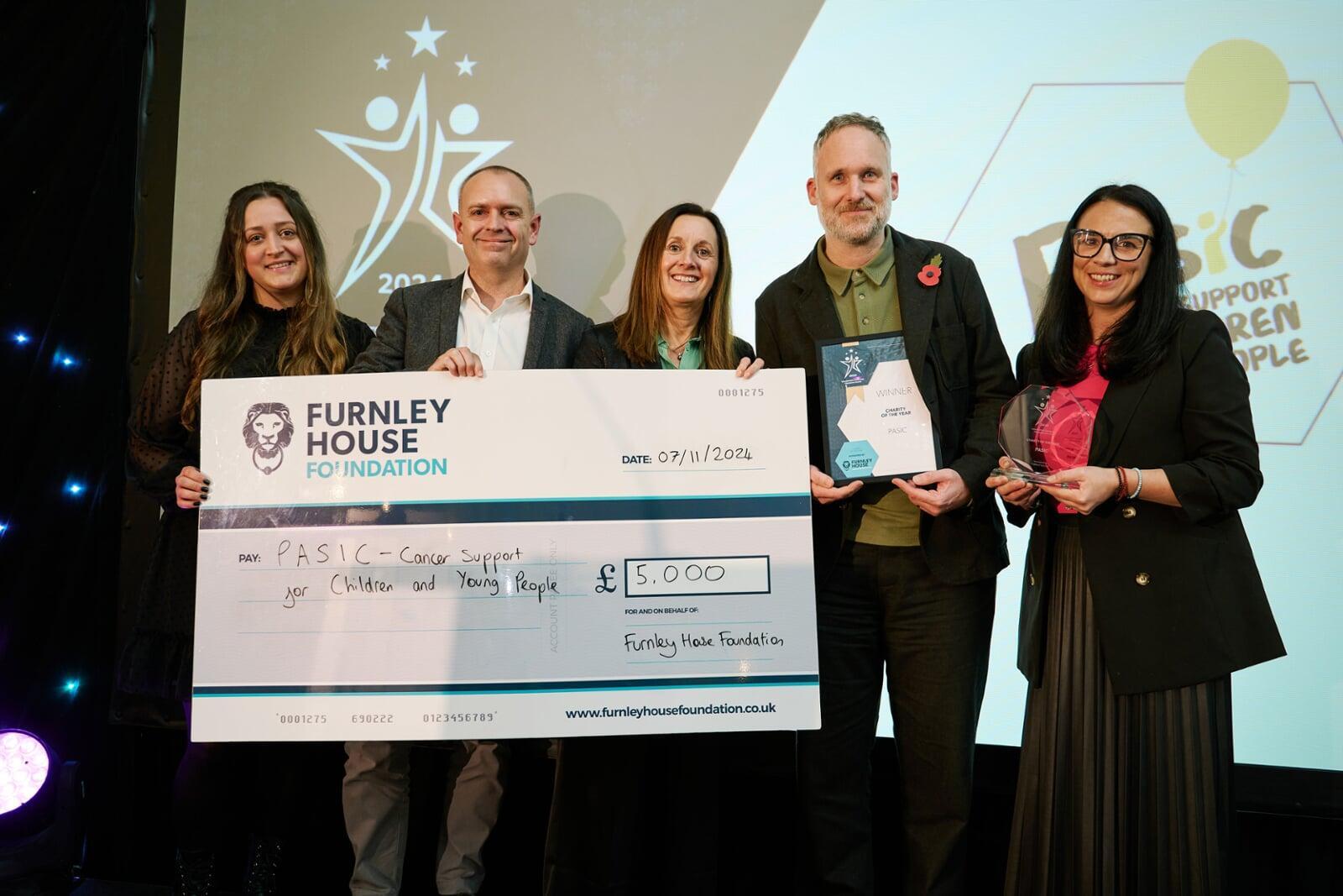 A charity being presented with a cheque 
